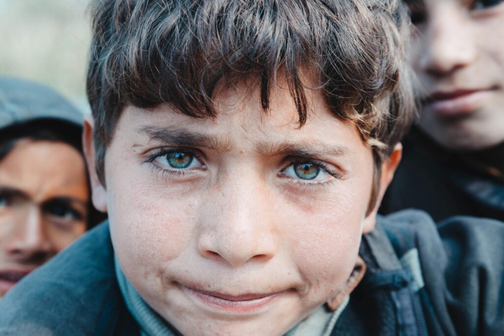 Close-up portrait of a young boy with expressive eyes in Faisalabad, Pakistan.